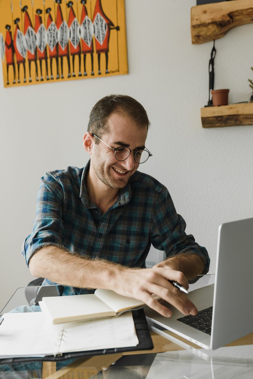 man in blue plaid dress shirt wearing black framed eyeglasses