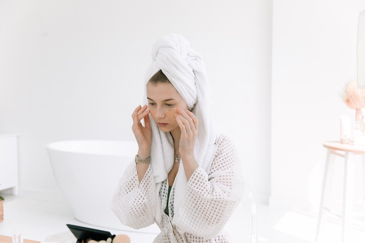 Woman applying skincare products