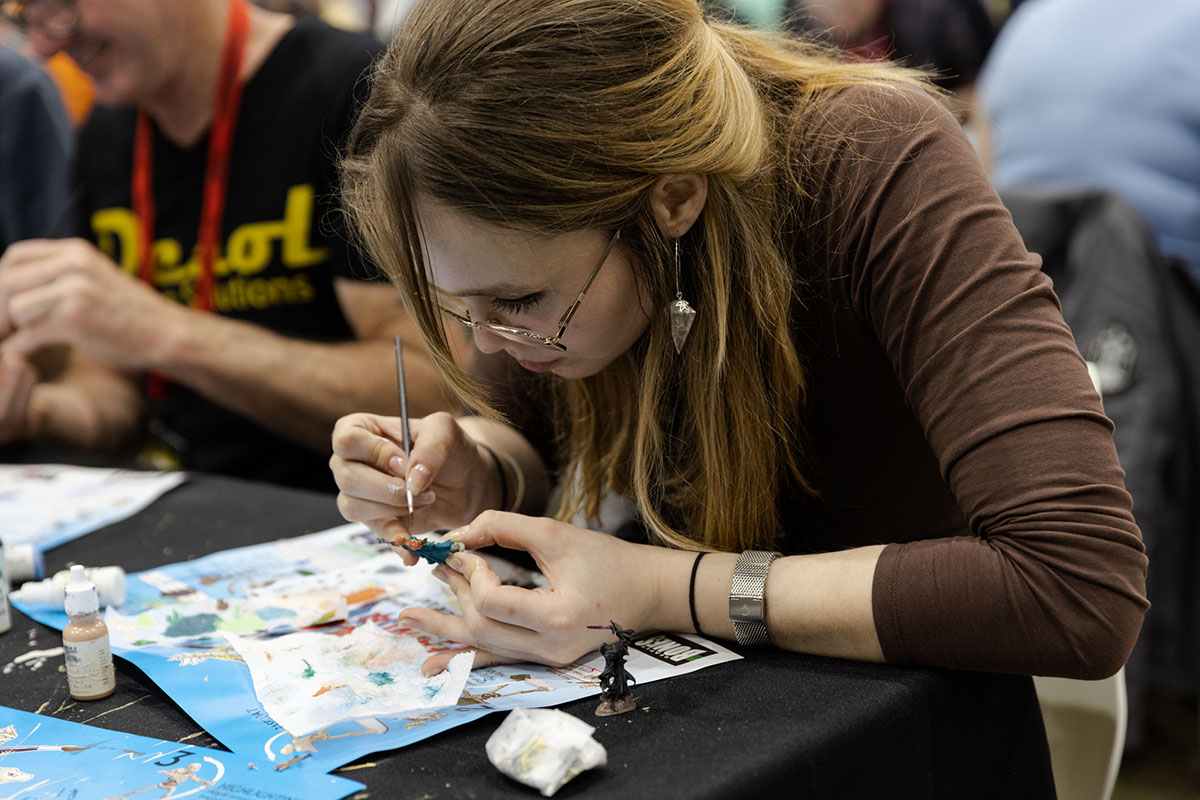 female painting a figurine